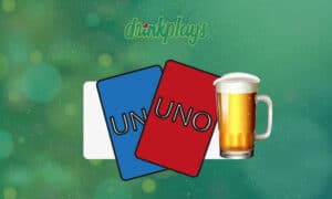 red and blue uno cards with a mug of beer
