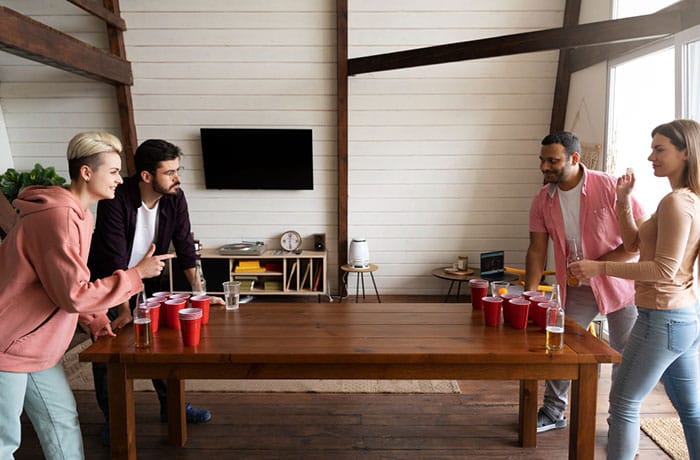 people playing beer pong indoor party